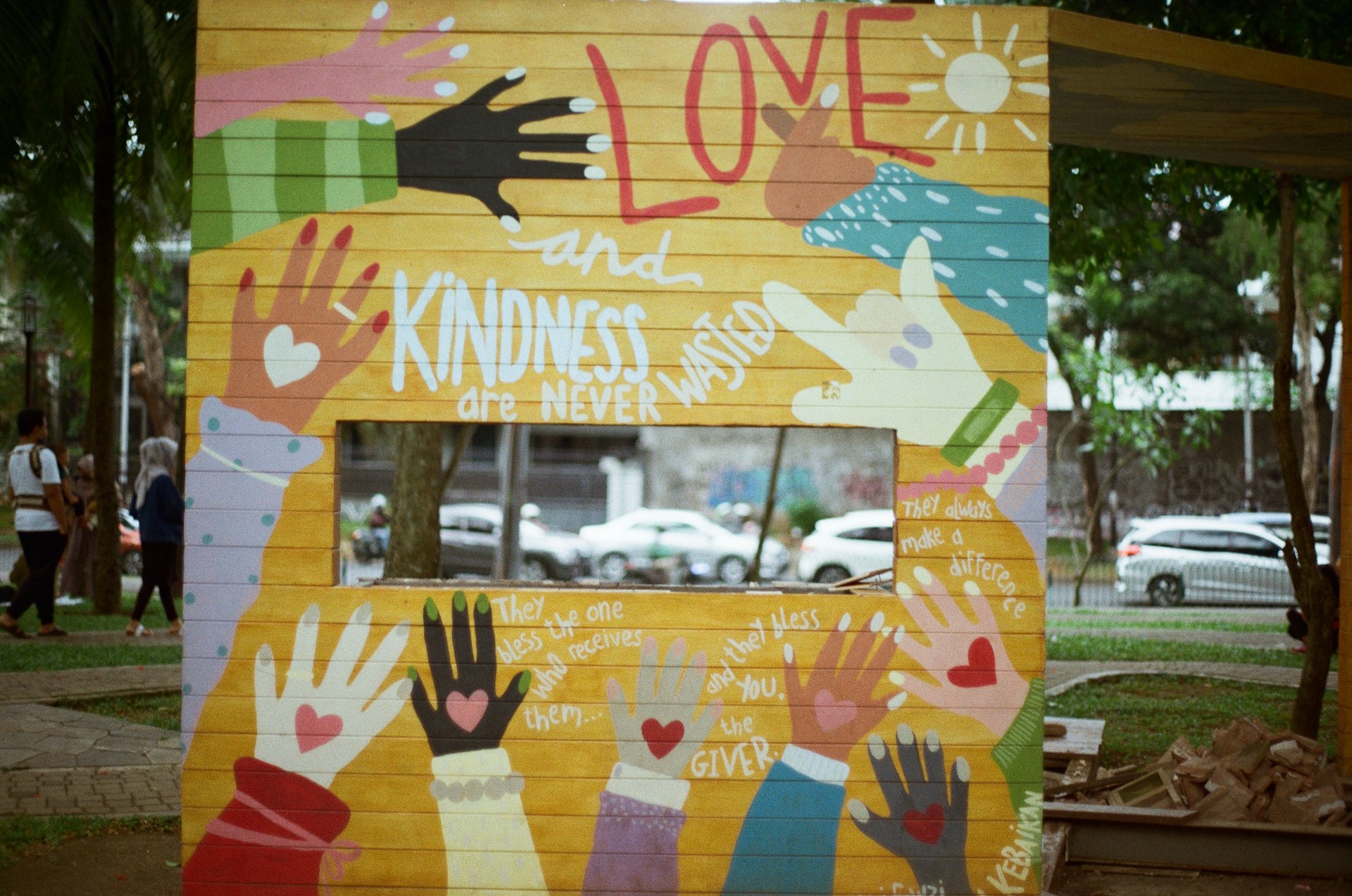 Colorful mural celebrating love, kindness and people helping one another